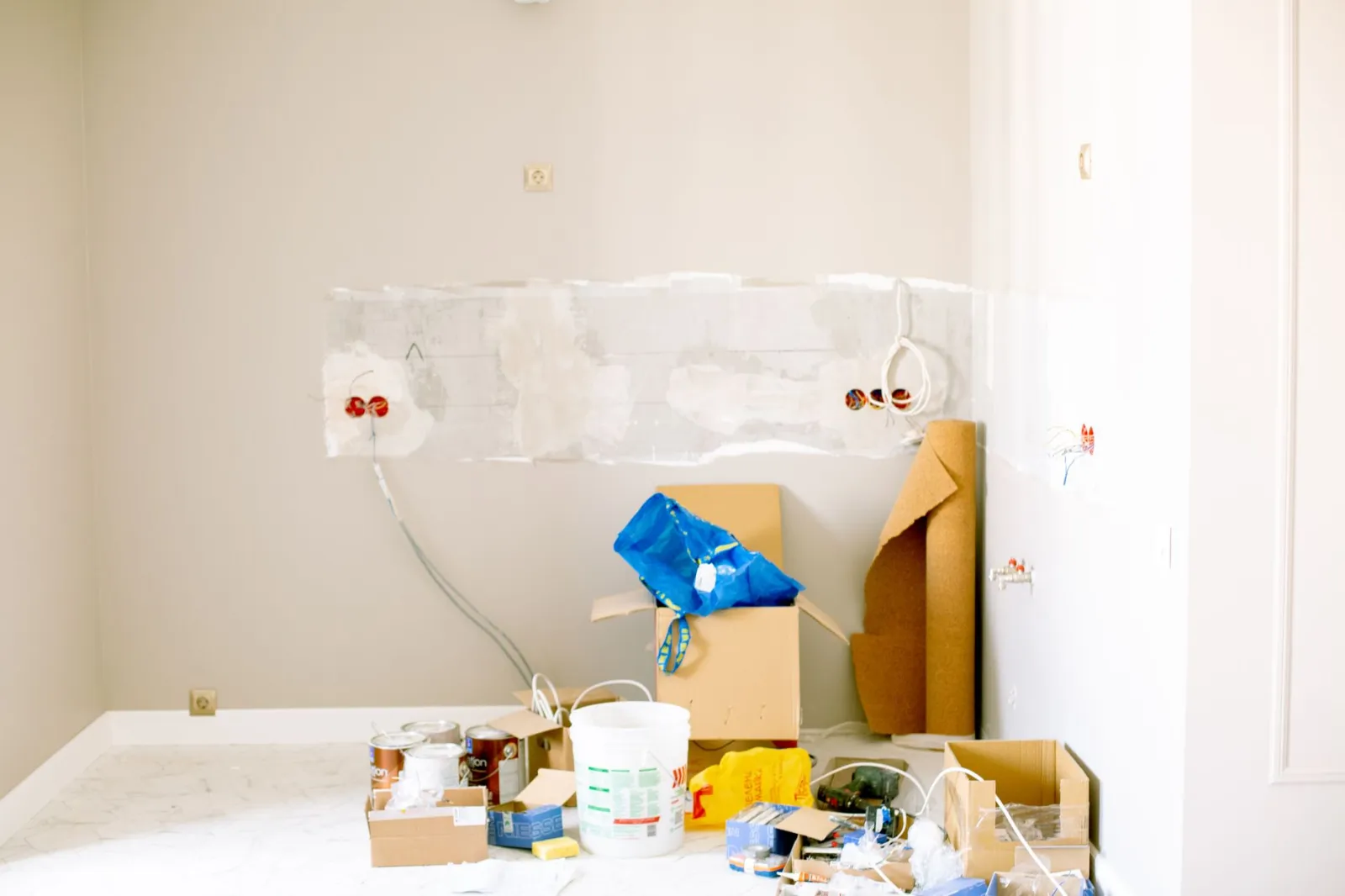 Couple comparing loan offers at a kitchen table with renovation plans