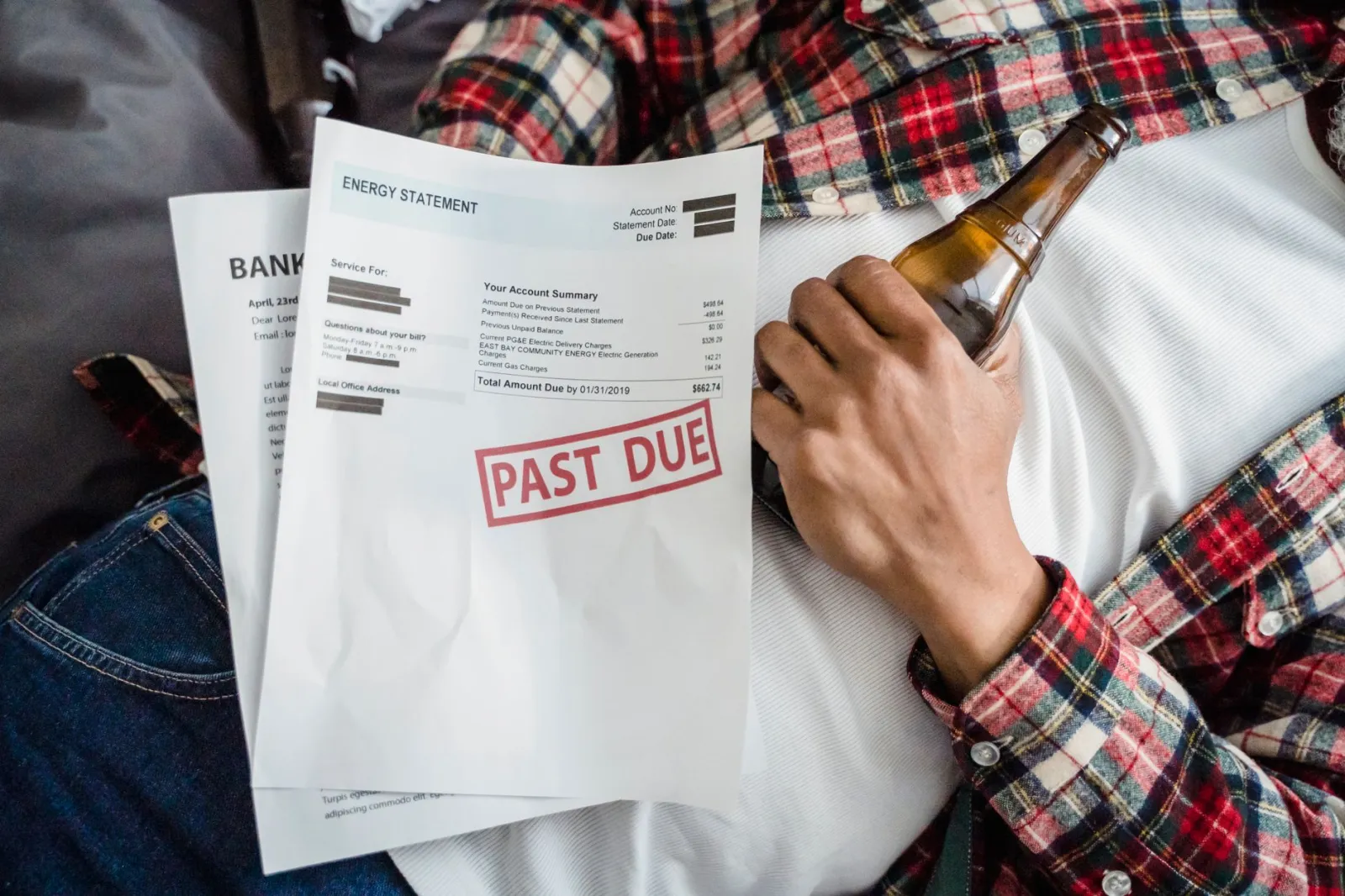 Homeowner comparing two utility bills at a kitchen table