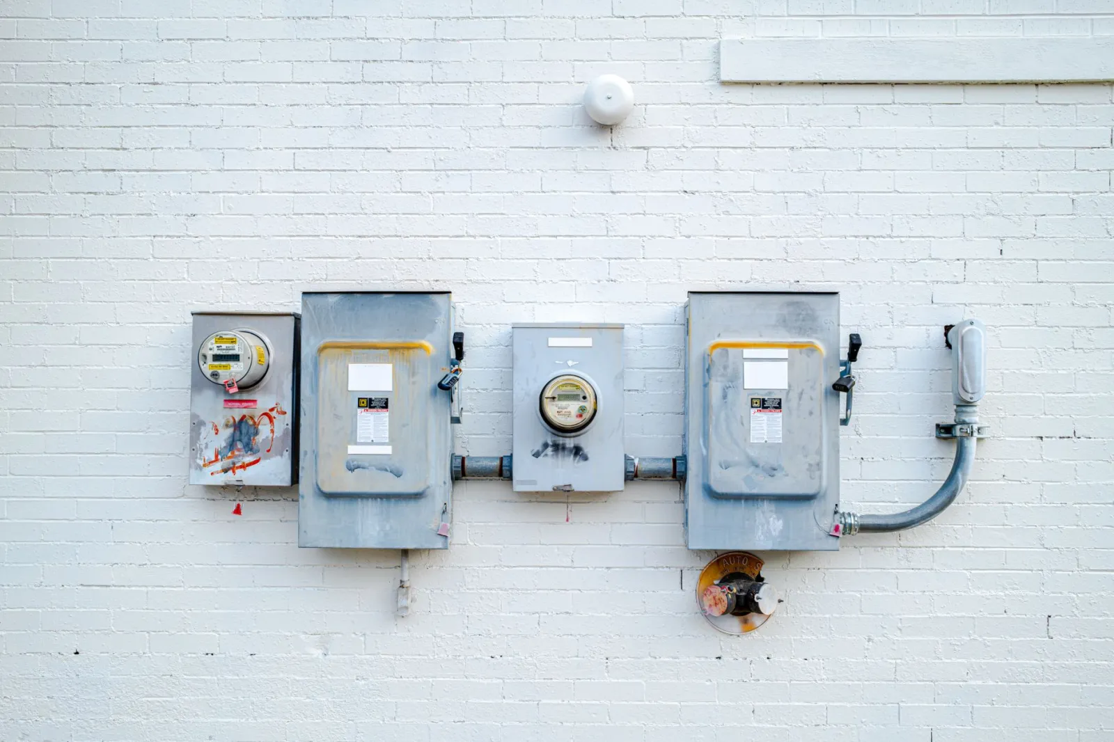 Electrician inspecting an open residential electrical panel with a voltage tester